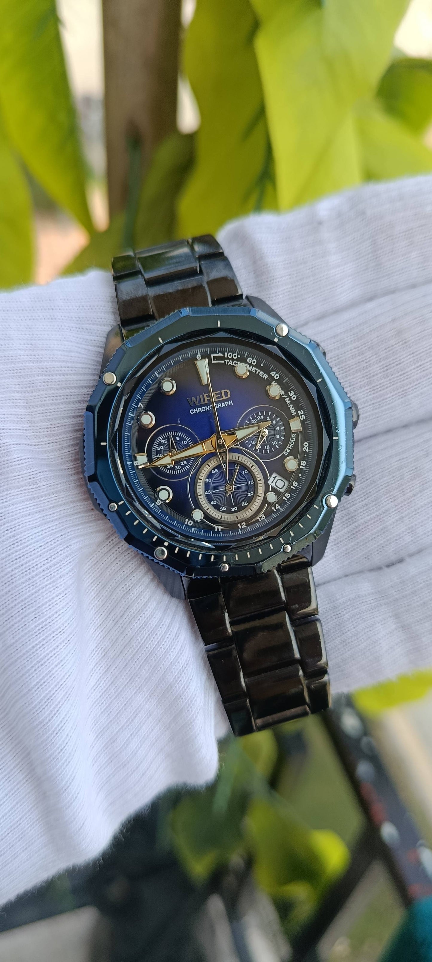 Seiko Wired Chronograph Watch | Blue Sunburst Multi-Dial Face | Tachymeter Bezel | 24-Hour Subdial | Date Display | Gold-Tone Hands | Black IP Stainless Steel Case & Bracelet | Movement 8T63