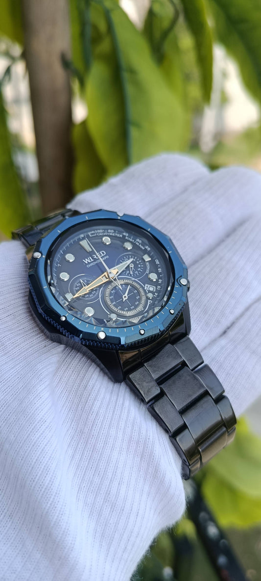 Seiko Wired Chronograph Watch | Blue Sunburst Multi-Dial Face | Tachymeter Bezel | 24-Hour Subdial | Date Display | Gold-Tone Hands | Black IP Stainless Steel Case & Bracelet | Movement 8T63