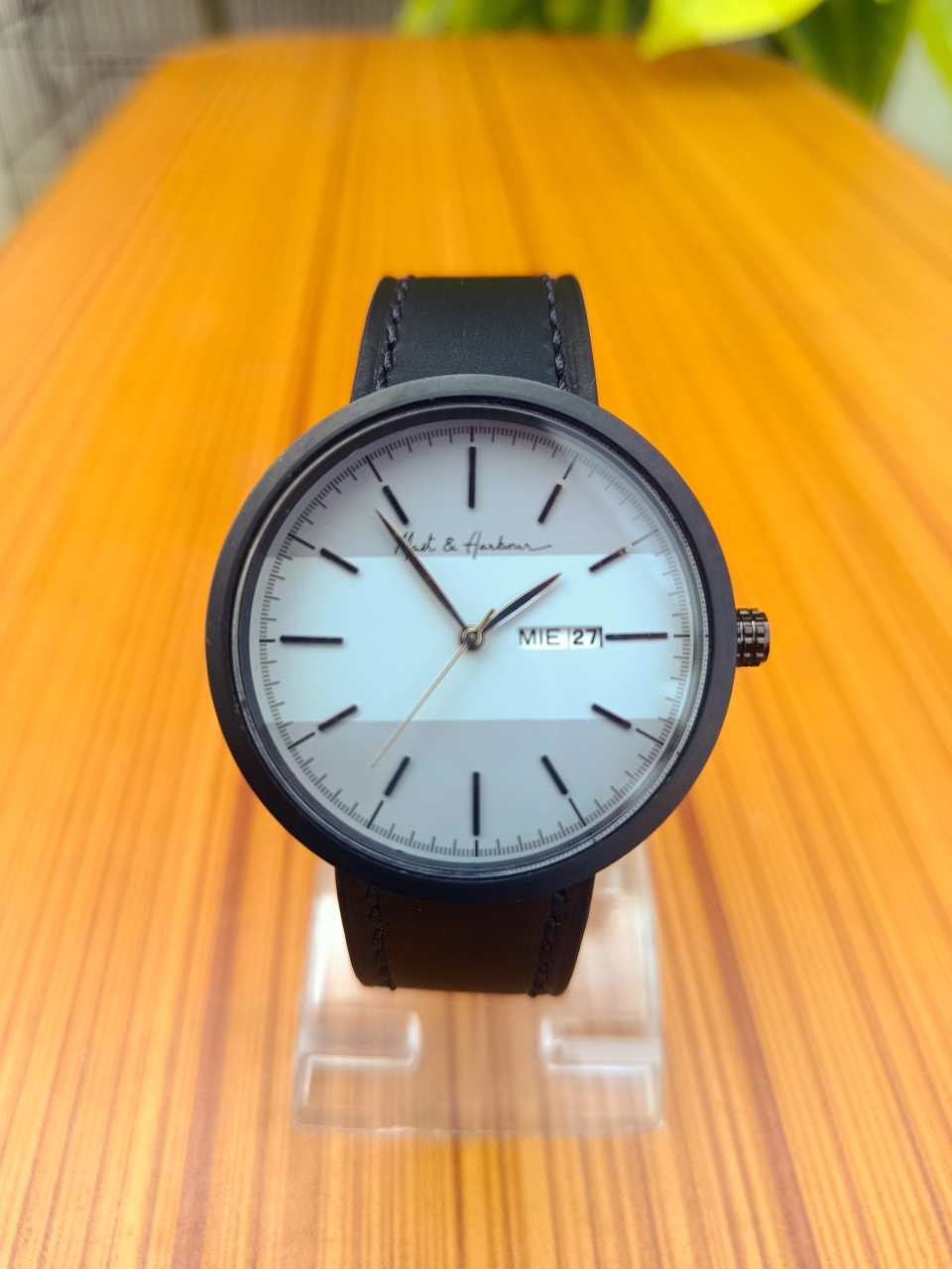 This is a Mast & Harbour analog watch with a black leather strap and white and grey dial.